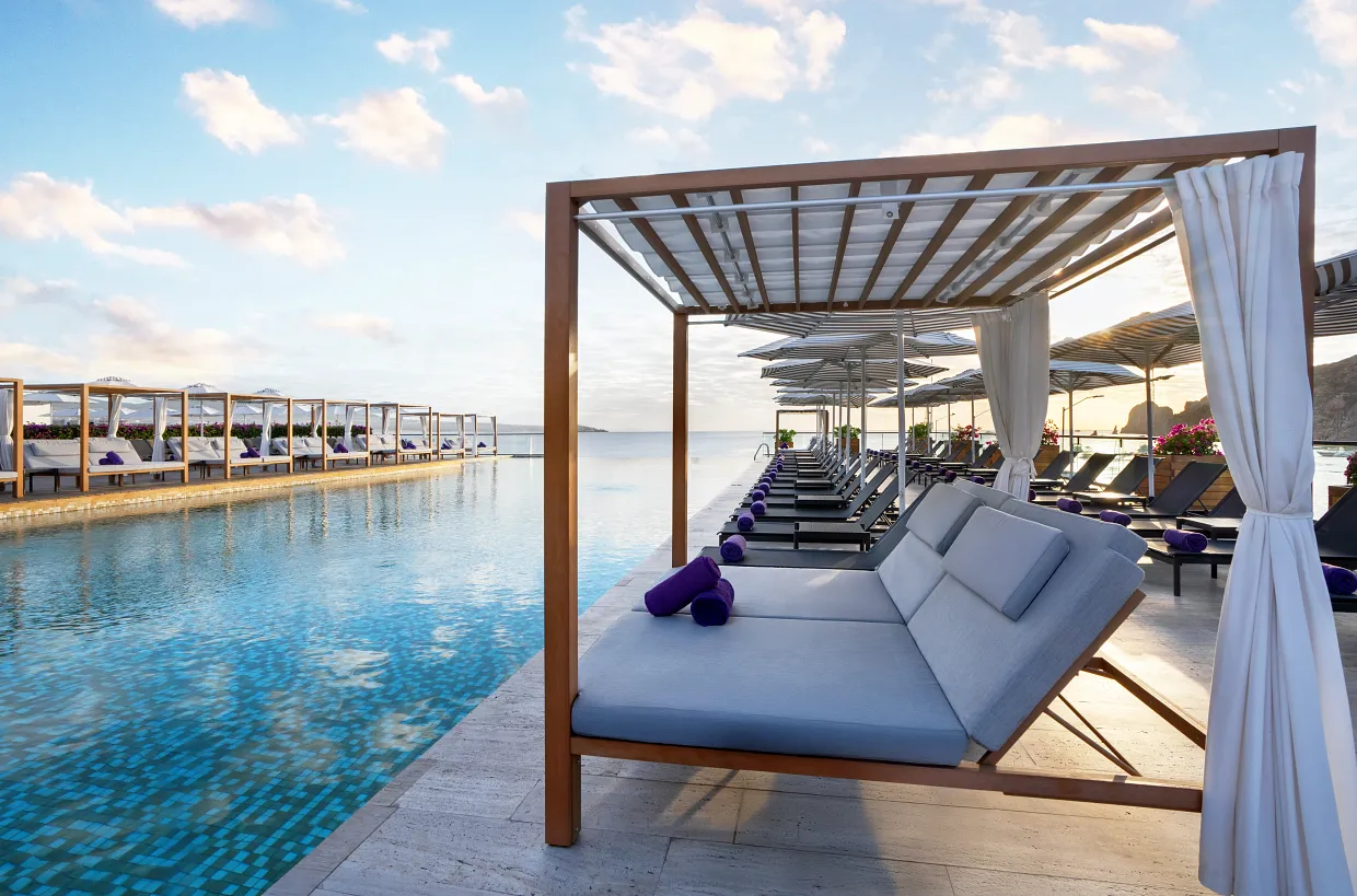 Luxurious poolside cabanas with ocean views at Breathless Cabo San Lucas Beach Club.
