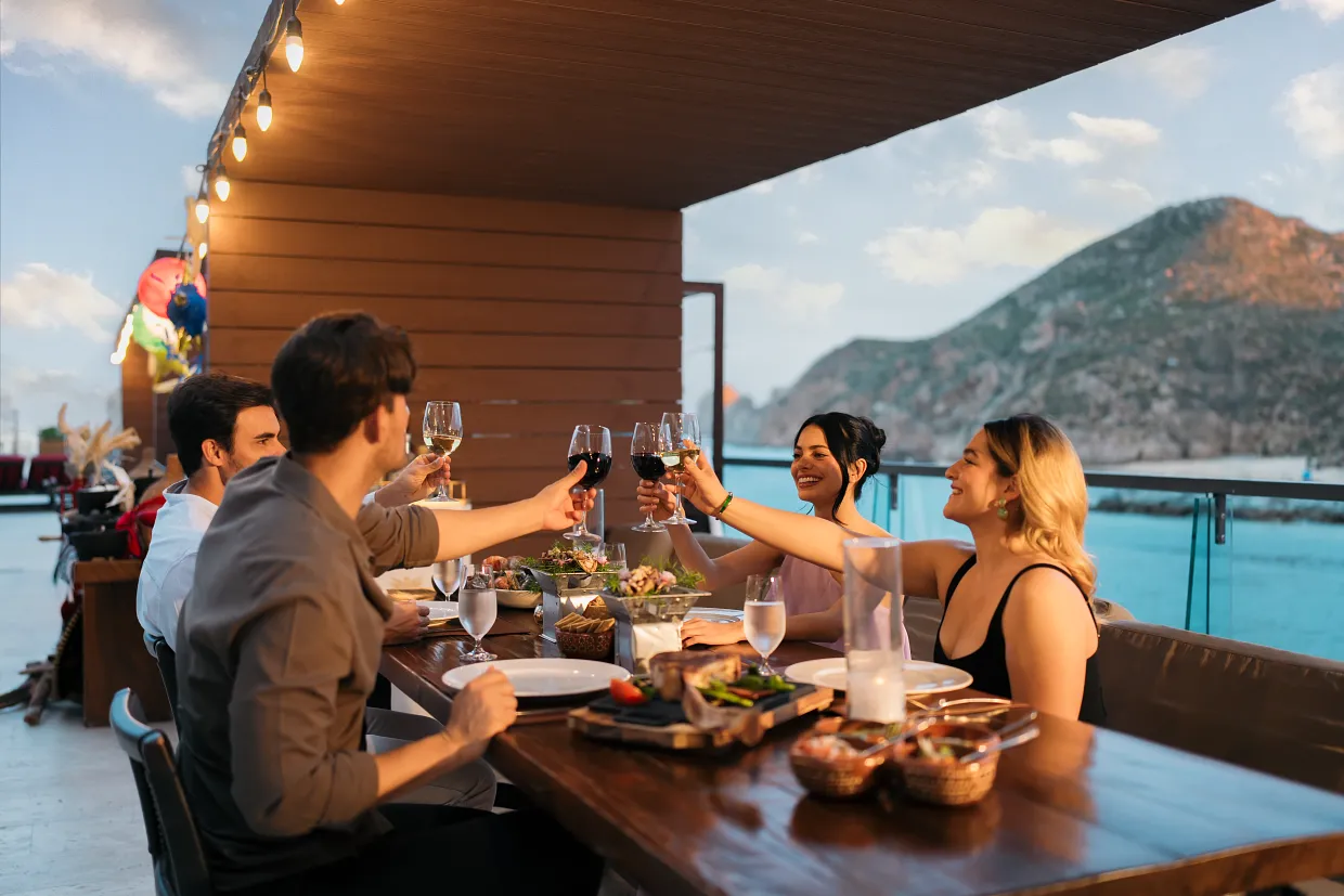 Guests enjoying dinner with marina views at Breathless Cabo San Lucas Restaurant.