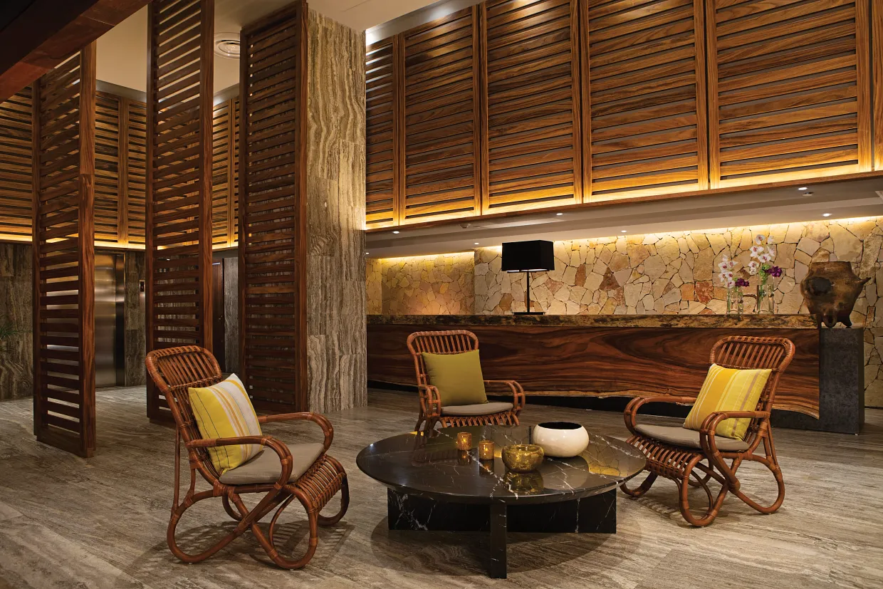 Elegant front desk and reception area at Breathless Cabo San Lucas with warm wood design.