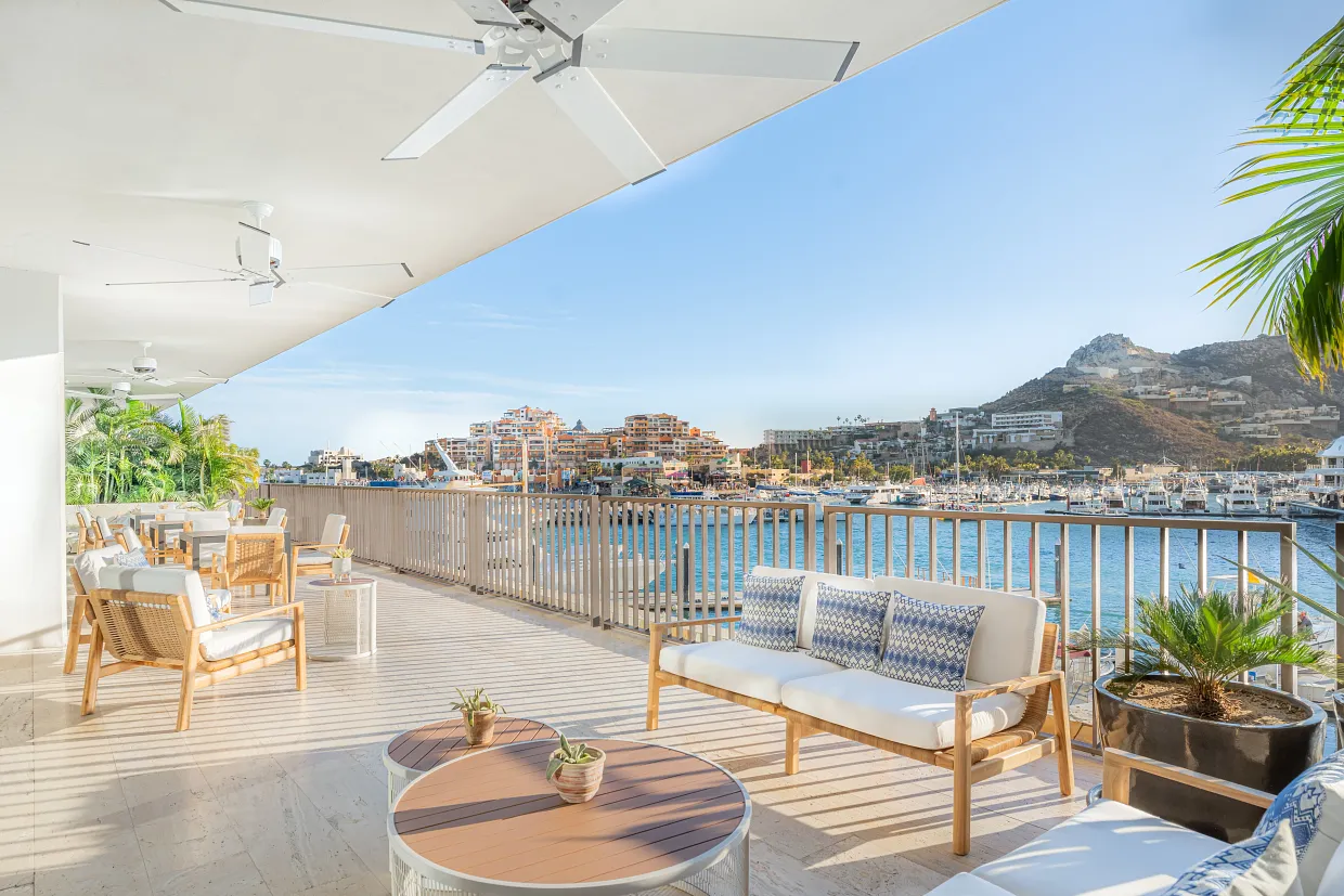 Outdoor xhale club terrace with comfortable seating and marina views at Breathless Cabo San Lucas.