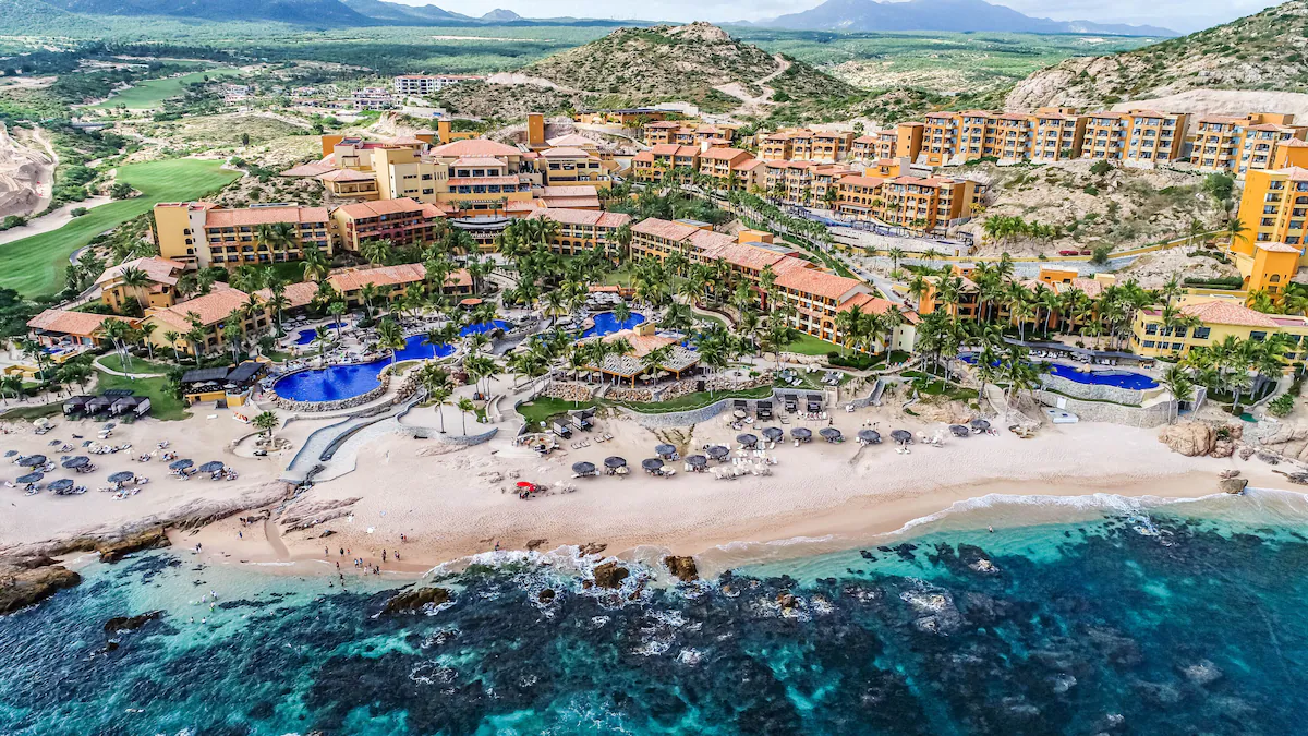 Grand Fiesta Americana Los Cabos aerial view with oceanfront pools, private beach areas, and hillside resort layout.