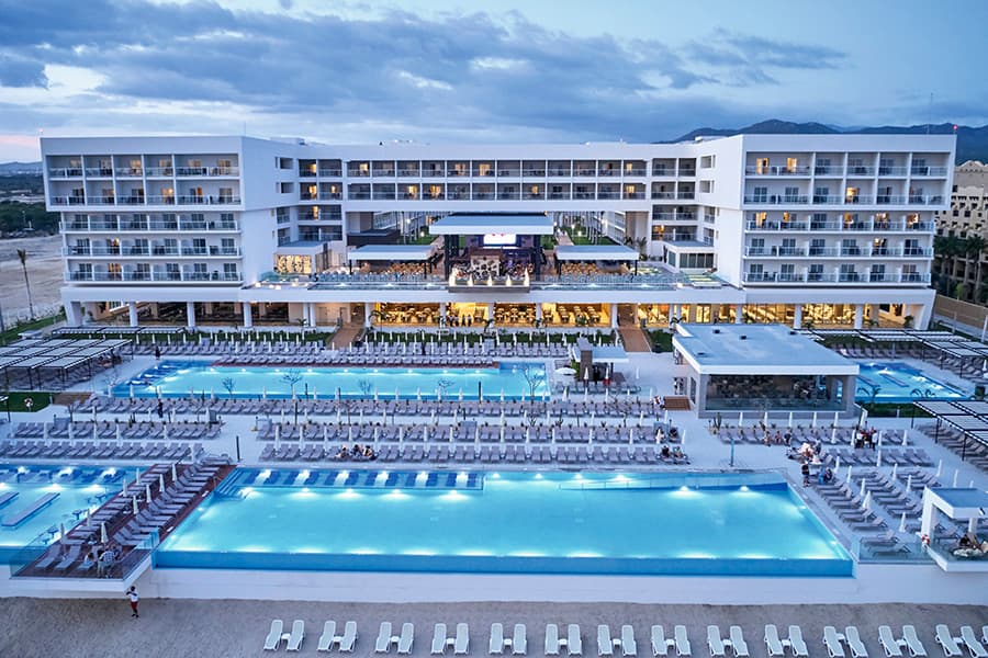 Riu Palace Baja California oceanfront pools and modern hotel tower overlooking Medano Beach.